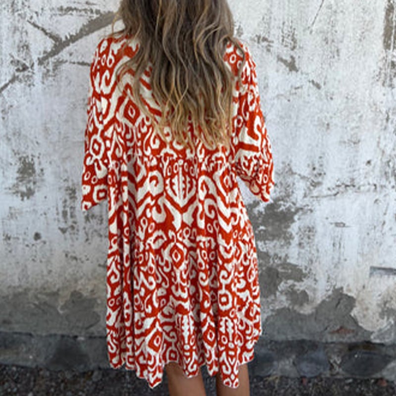 Azalea draped dress in orange colorway styled for a casual daytime look