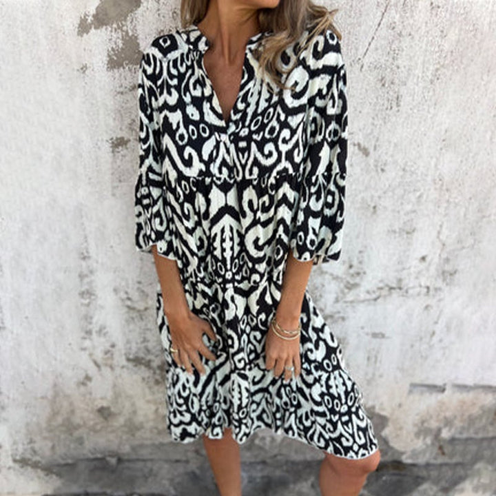 Full-length lifestyle shot of model wearing the Azalea printed draped dress