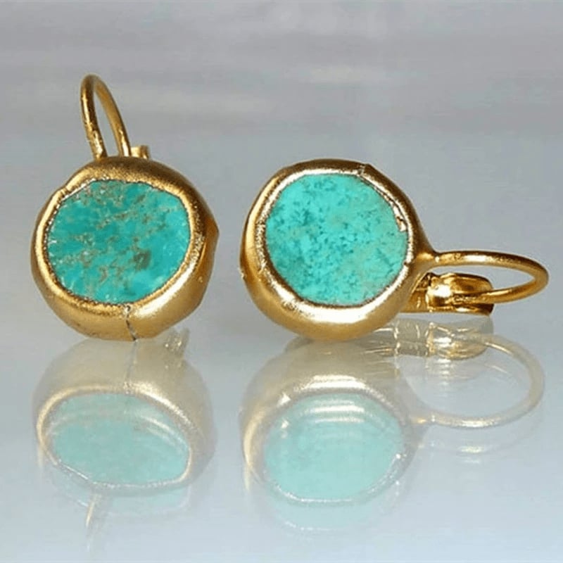Gold-tone earrings featuring a vibrant turquoise stone centerpiece, shown against a clean background