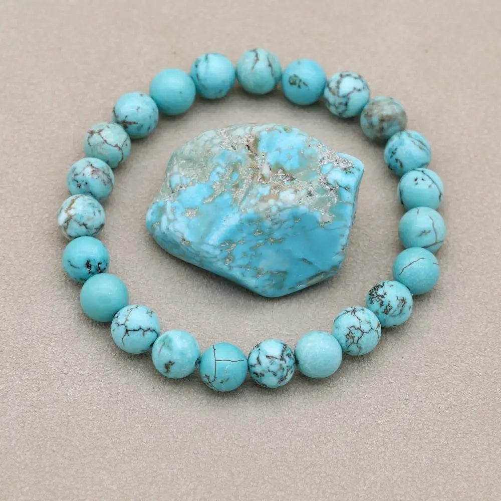 Turquoise bracelet styled on a wrist against a light background