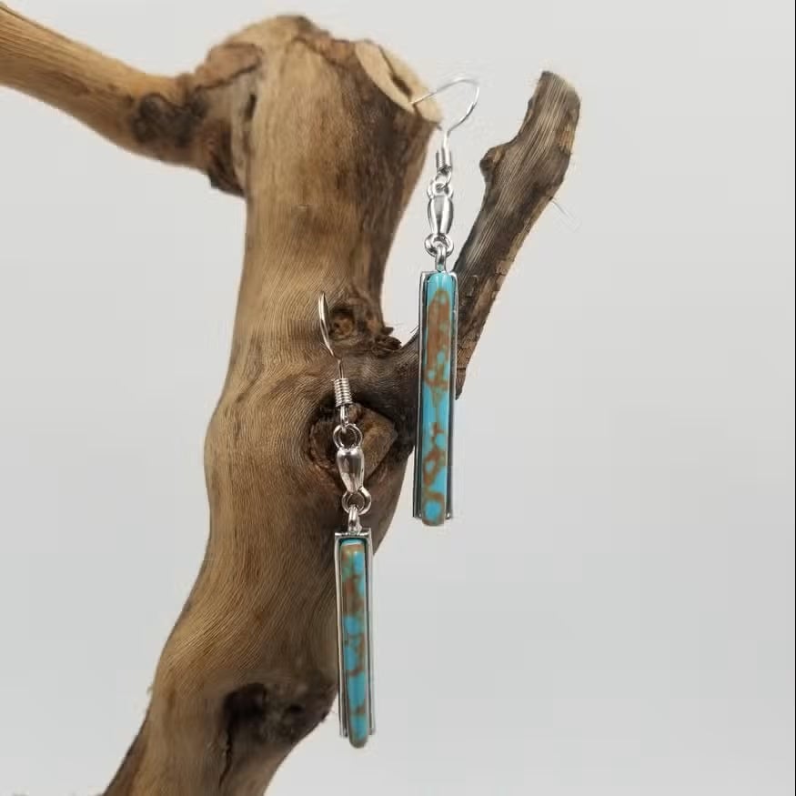 Pair of vintage turquoise drop earrings laid flat showing full size and color detail