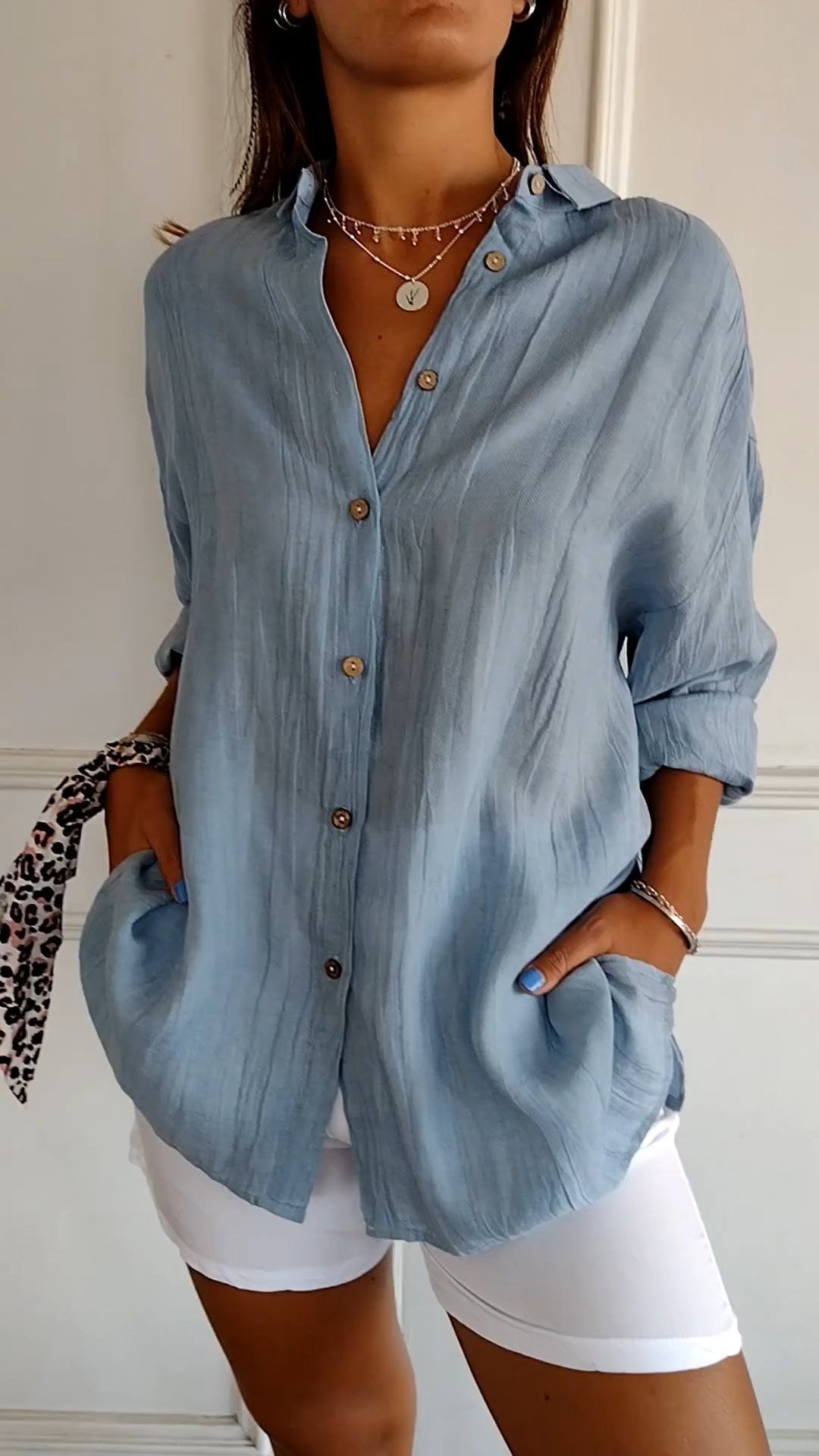 Front view of the Azure oversized linen-look button-down shirt in blue with wooden-tone buttons and spread collar