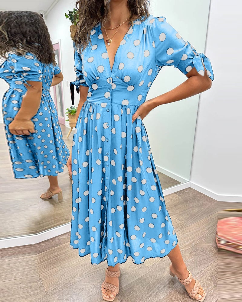 Close-up of polka dot print and button closure on V-neck dress