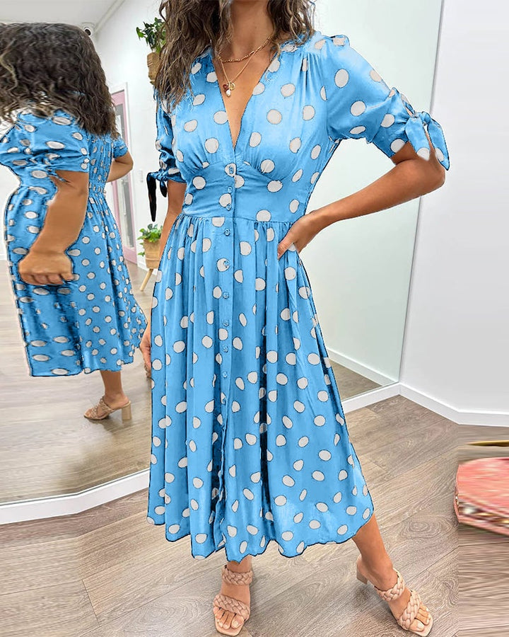 Close-up of polka dot print and button closure on V-neck dress