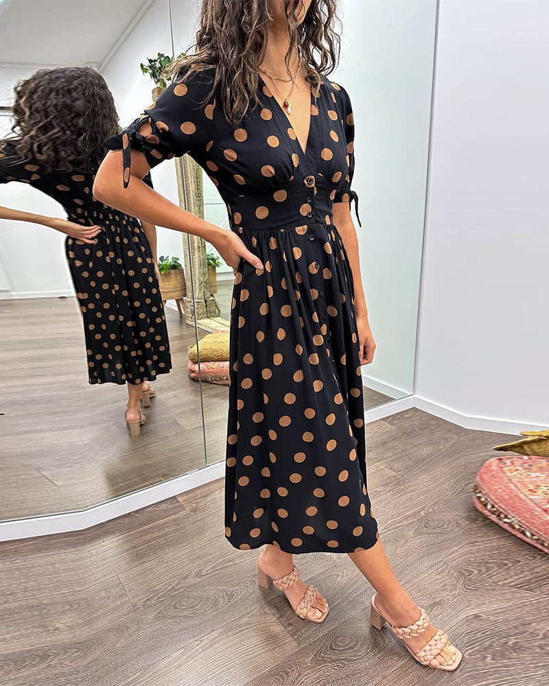 Woman in green polka dot midi dress styled for a casual daytime look