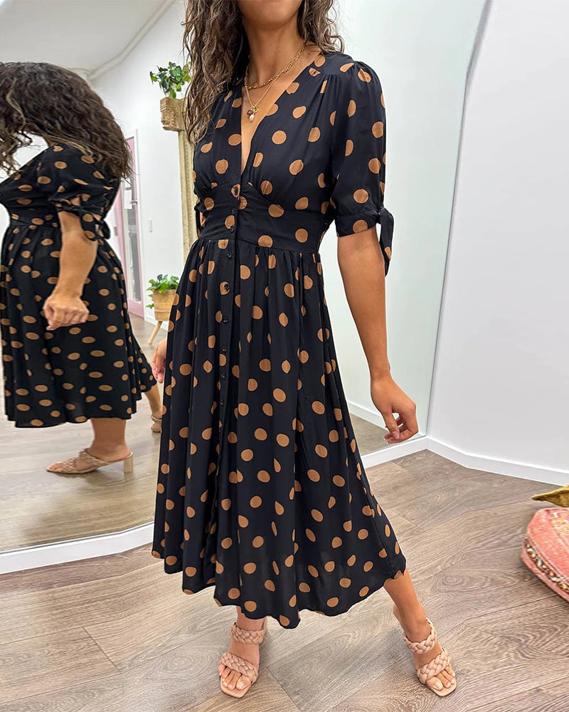 Purple polka dot V-neck dress on model showing full-length silhouette