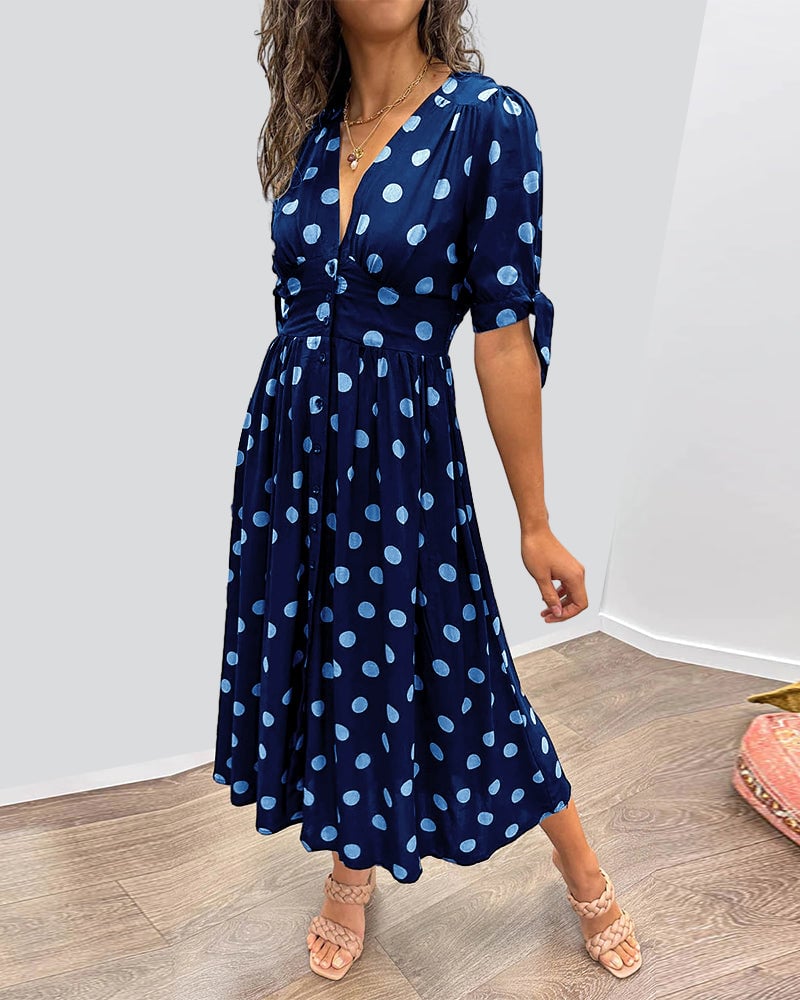 Back view of polka dot V-neck midi dress showing clean finish and fit