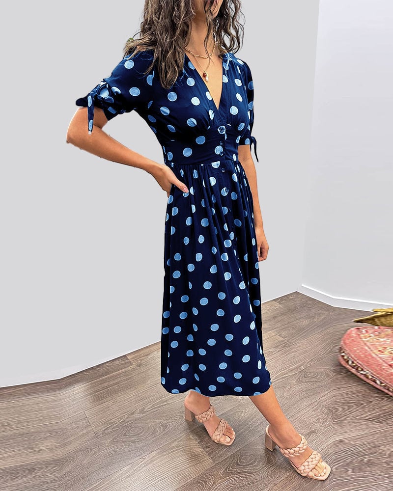Model wearing black polka dot dress with heels for an evening outfit