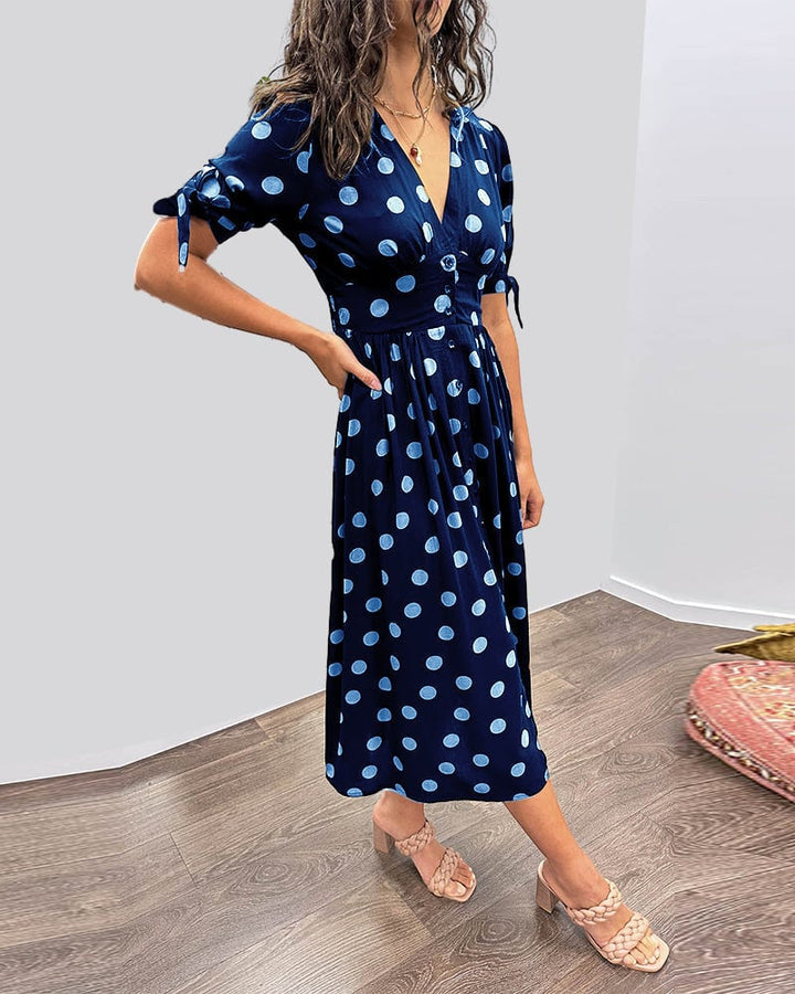 Model wearing black polka dot dress with heels for an evening outfit