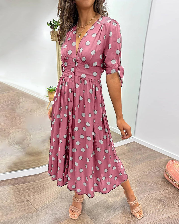 Full-length front view of polka dot midi dress in dark blue colorway