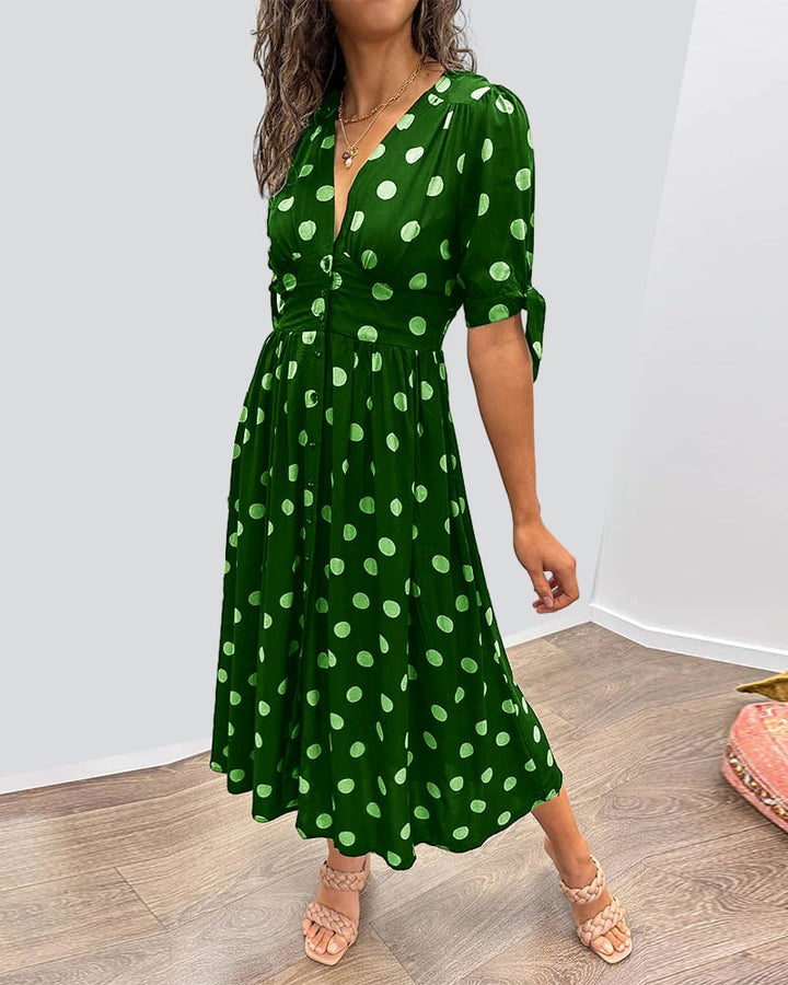 Flat lay of polka dot V-neck dress showing print and overall design