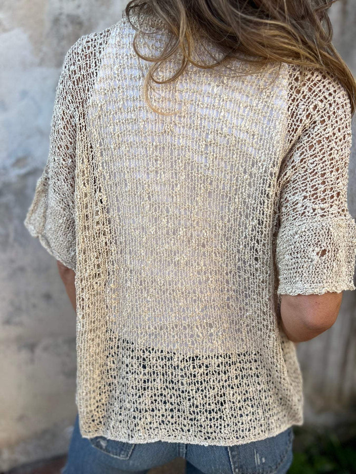 Back view of the elegant textured knit top in black, showing the flattering silhouette and knit pattern