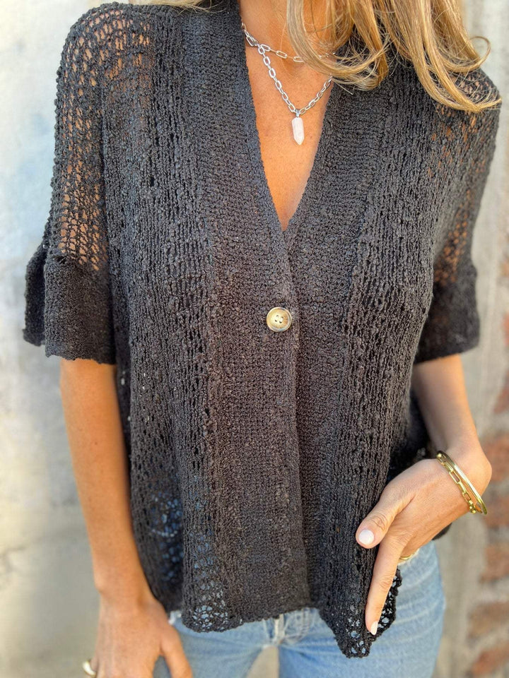 Side profile of the apricot knit top showing the relaxed yet structured fit from neckline to hem