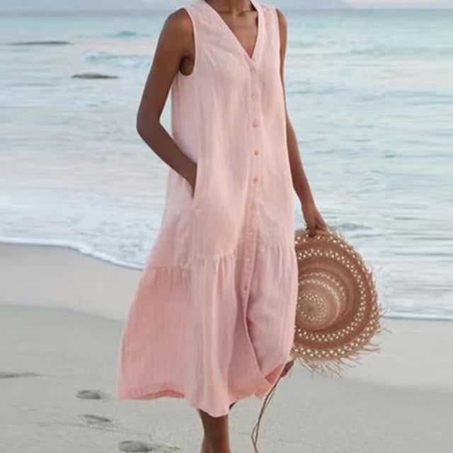 Side view of sleeveless buttoned midi dress in pink highlighting the flattering midi length
