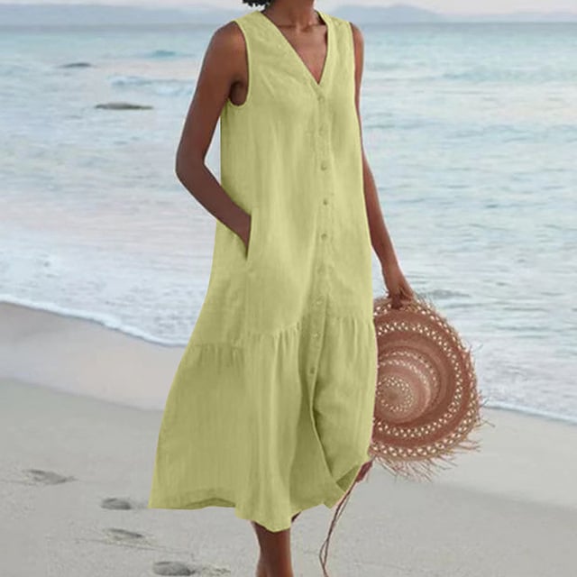 Model in green sleeveless buttoned midi dress showing relaxed silhouette and breathable cut