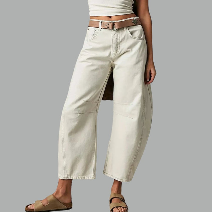 Full-length front view of barrel leg jeans in dark blue denim