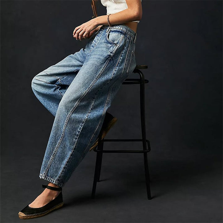 Back view of dark gray barrel leg jeans showing tapered ankle