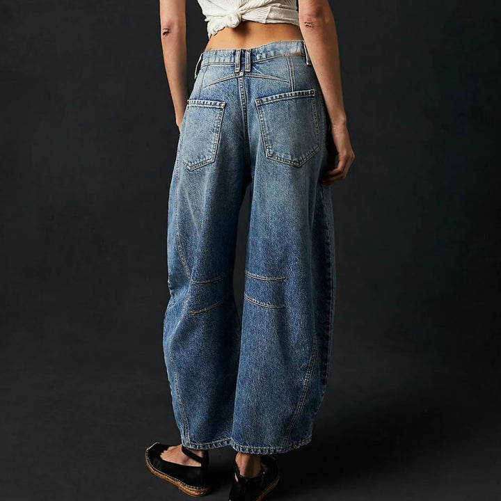 Full-length view of barrel leg jeans in black denim
