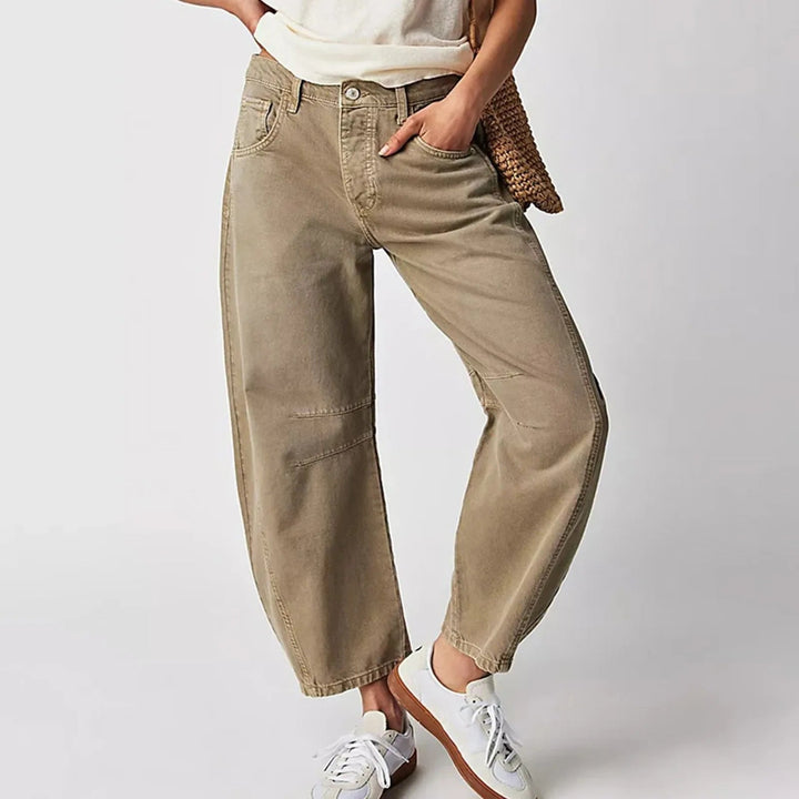 Full-length view of white barrel leg jeans styled with a fitted top