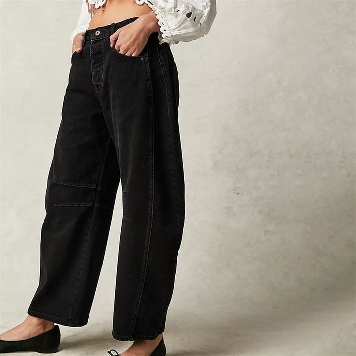 Side view of beige high waist barrel leg jeans