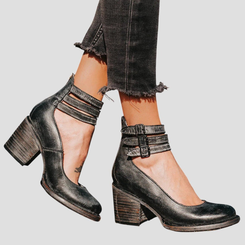 Front view of stylish ankle-to-mid-calf boots in black with a smooth, sleek silhouette