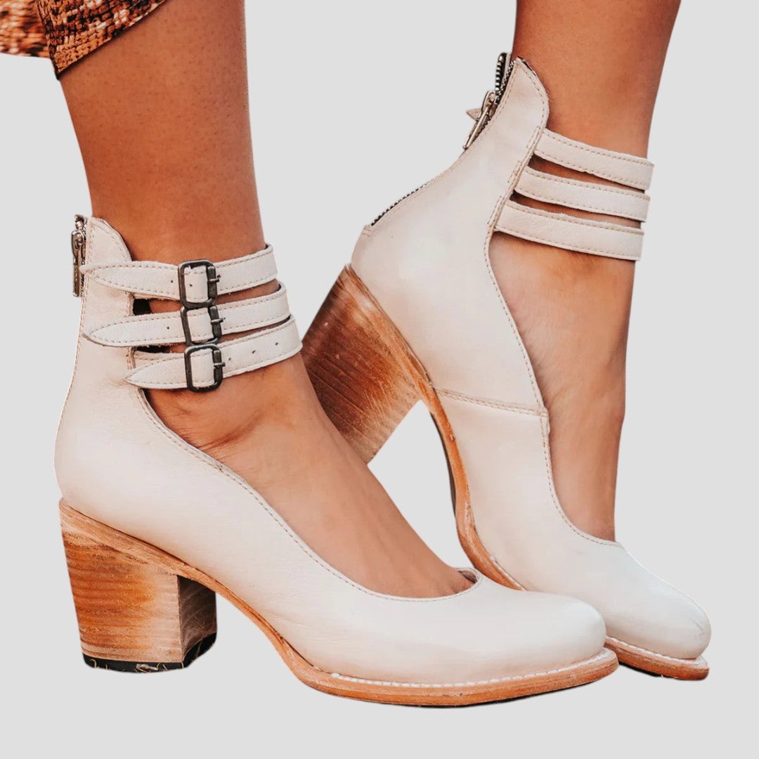 Women's boots in cream color styled with casual outfit on neutral background