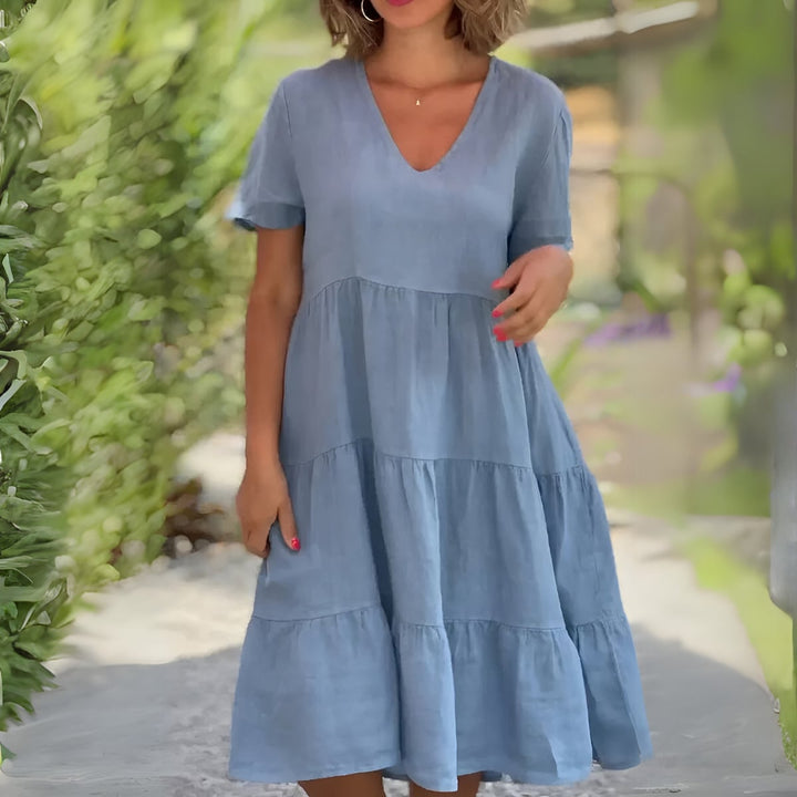 Front view of the Beatrice tummy control dress in blue highlighting the elegant V-neckline and relaxed fit
