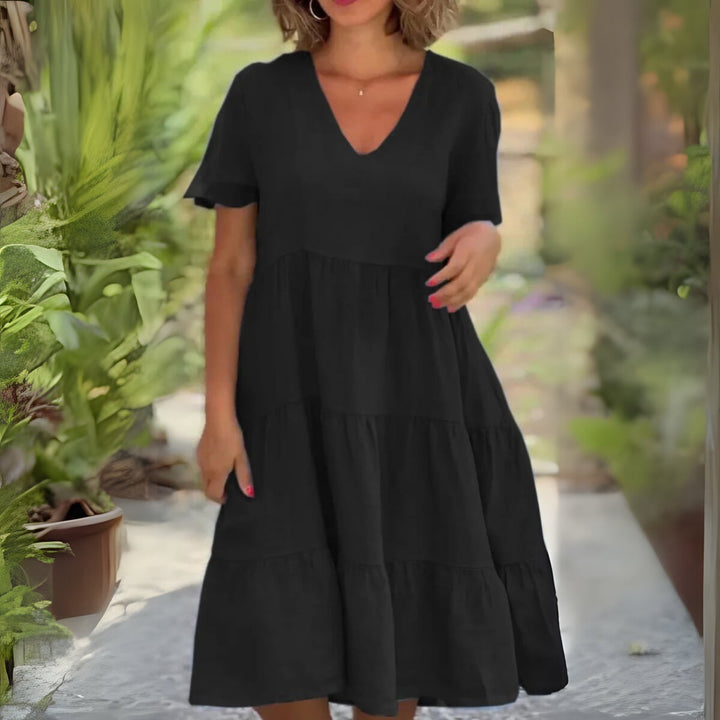 Side view of the Beatrice flowy dress in black showing graceful movement and smooth fabric drape