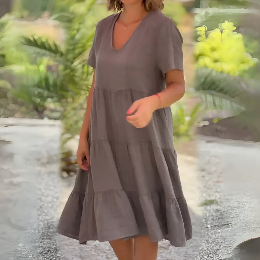 Close-up of the Beatrice dress neckline and fabric texture in grey demonstrating lightweight breathable material