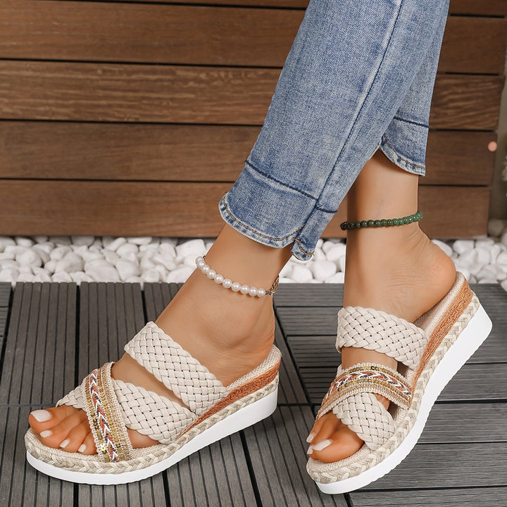 Side profile of Beatrice beige slip-on sandals showing lightweight flexible sole