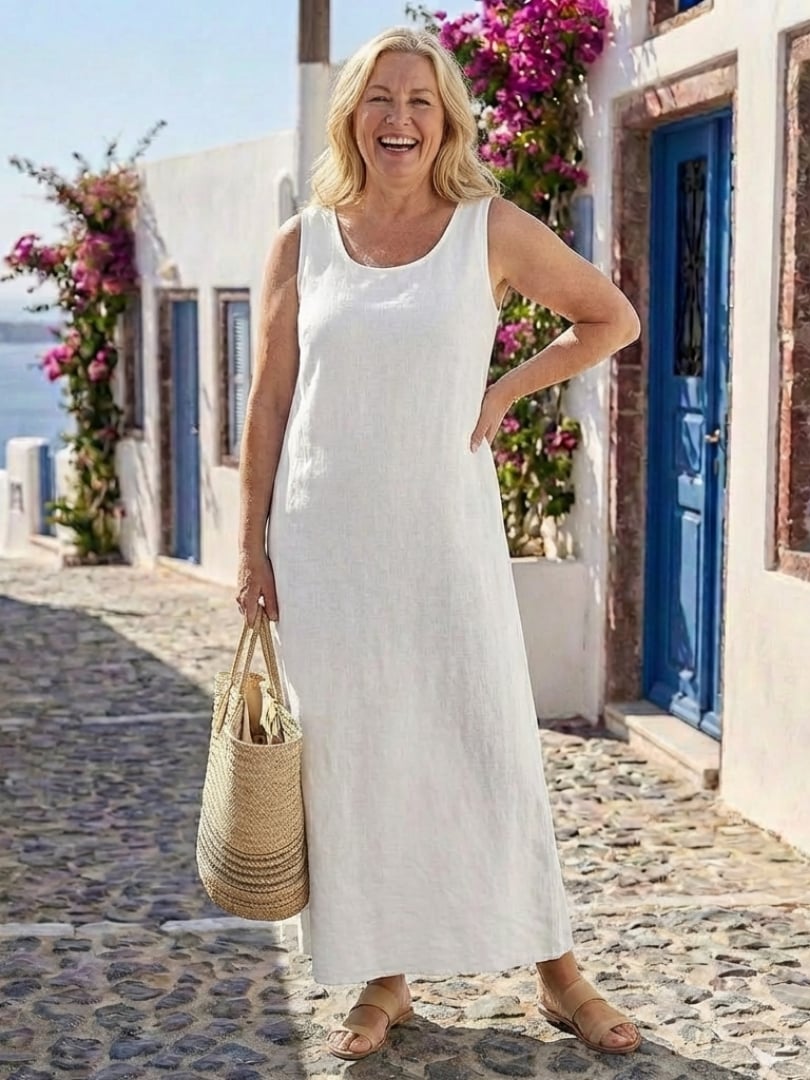 Side view of a white sleeveless maxi dress showing the relaxed fit and full-length hemline