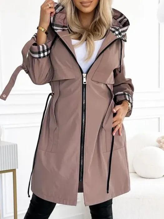 Woman wearing a waterproof windproof zip coat with hood in brown, front view, styled for everyday wear