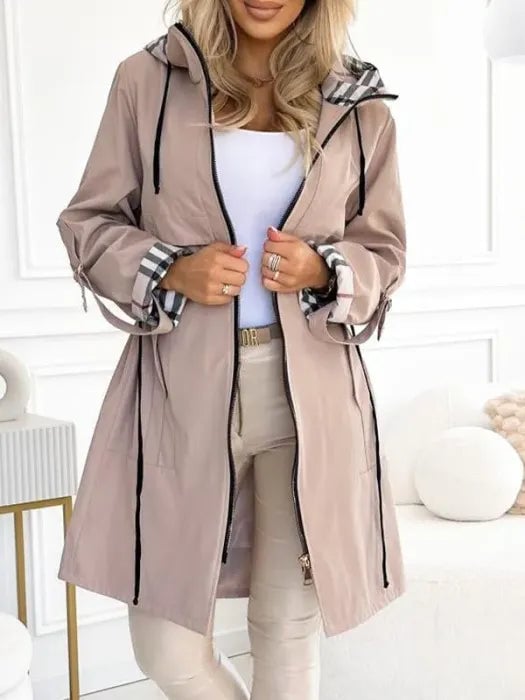 Close-up detail of the waterproof zip coat showing the hood and zip closure in beige