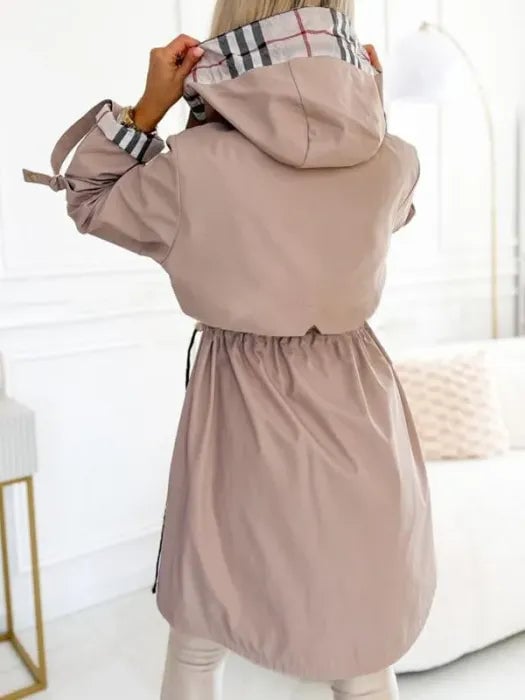 Flat lay of the waterproof zip coat in brown displaying the lightweight construction and clean finish
