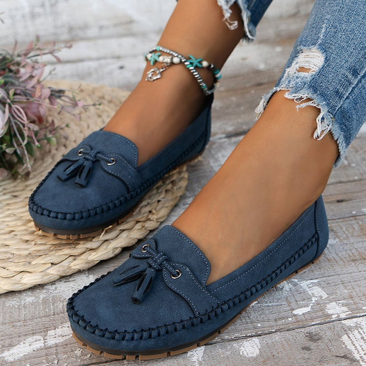 Front view of soft bow loafers in blue with cushioned insole and classic bow detail