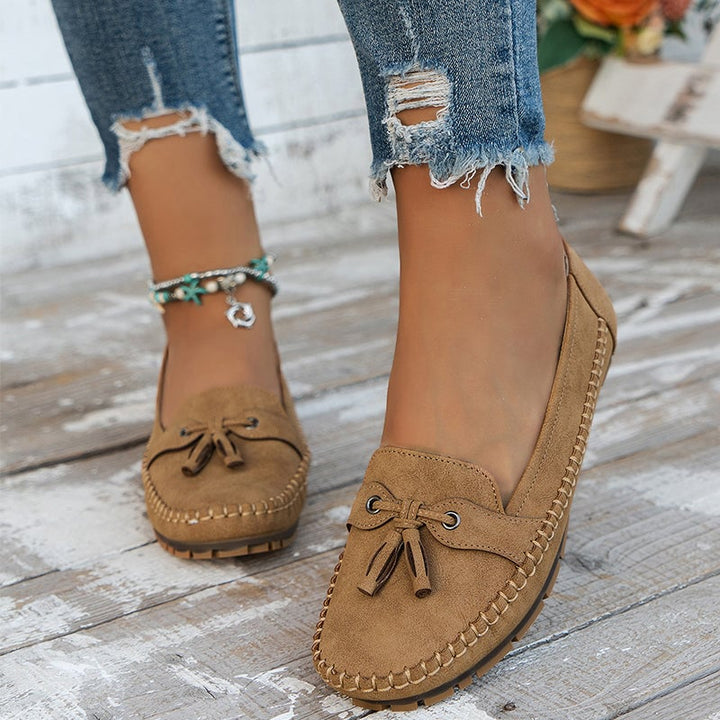 Close-up of bow detail on brown comfort loafers for women