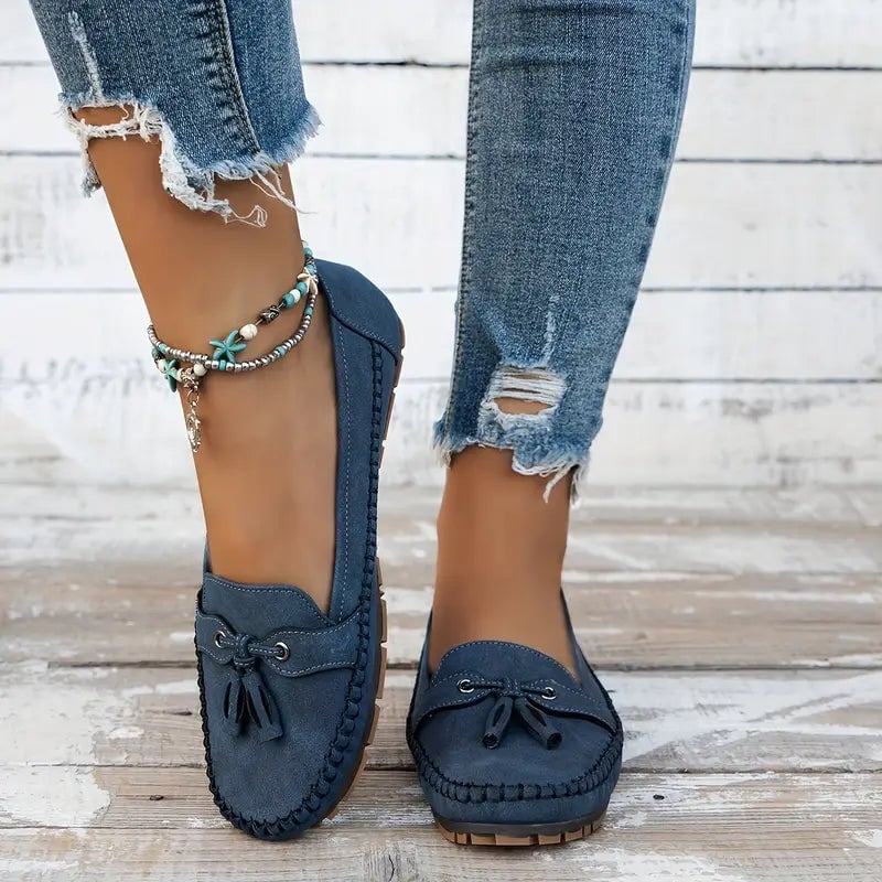 Women's blue loafers with orthopedic support shown on a flat surface