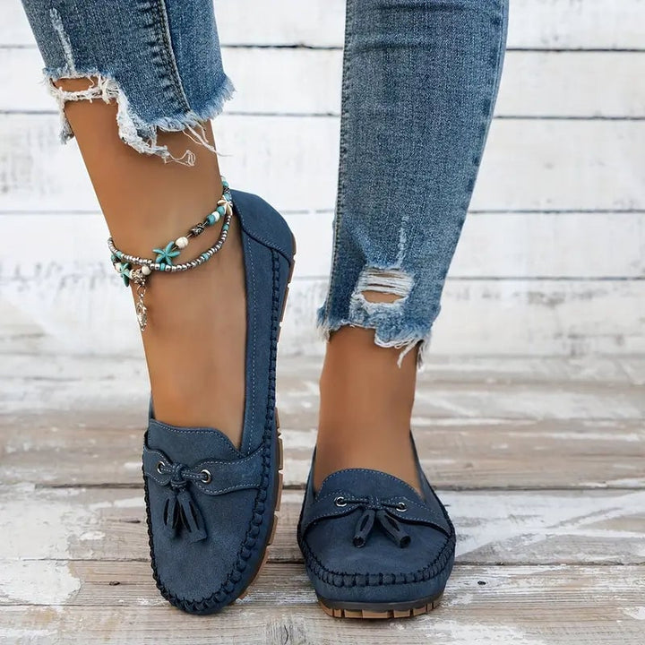 Women's blue loafers with orthopedic support shown on a flat surface