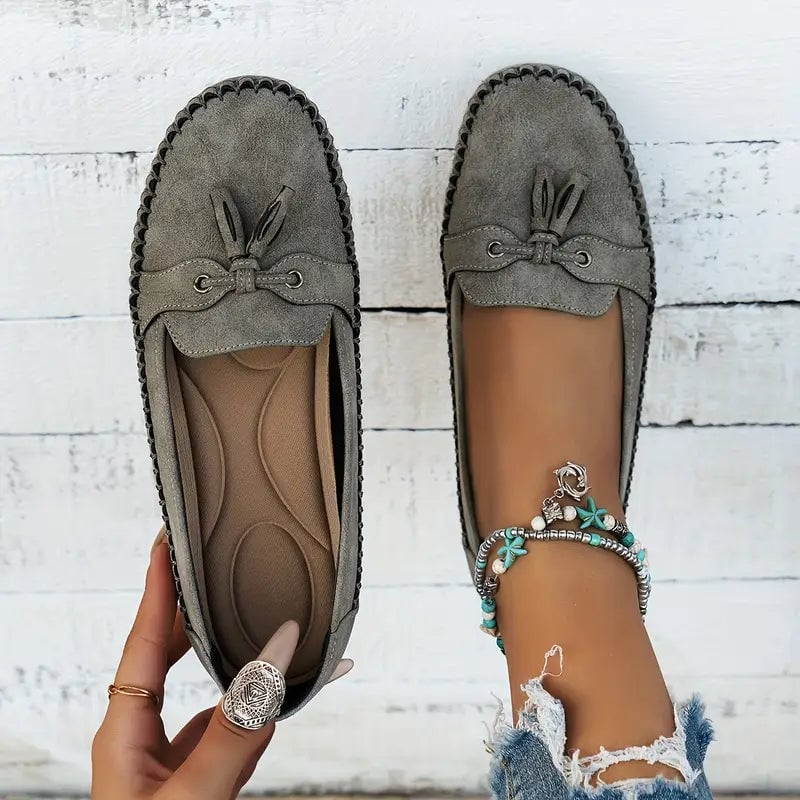 Pair of gray women's loafers with cushioned insole displayed side by side