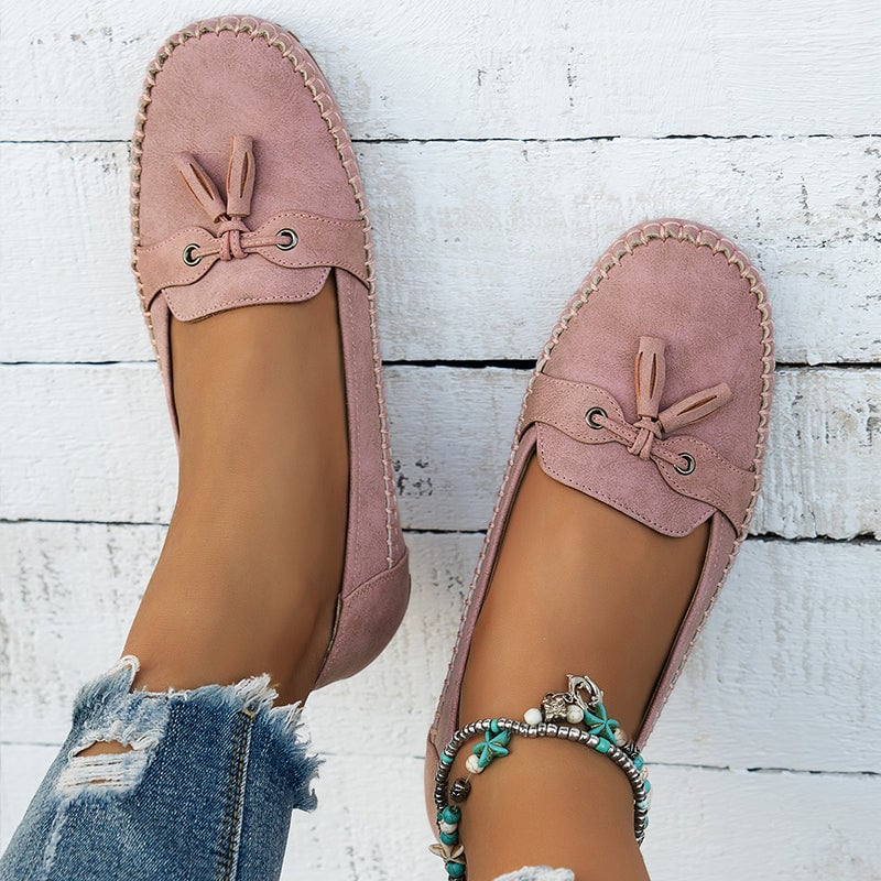 Gray women's loafers styled with wide-leg trousers for a casual look