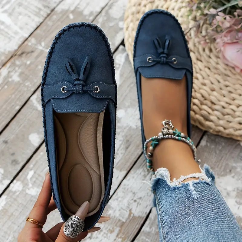 Brown comfort loafers shown in a flat lay styling shot