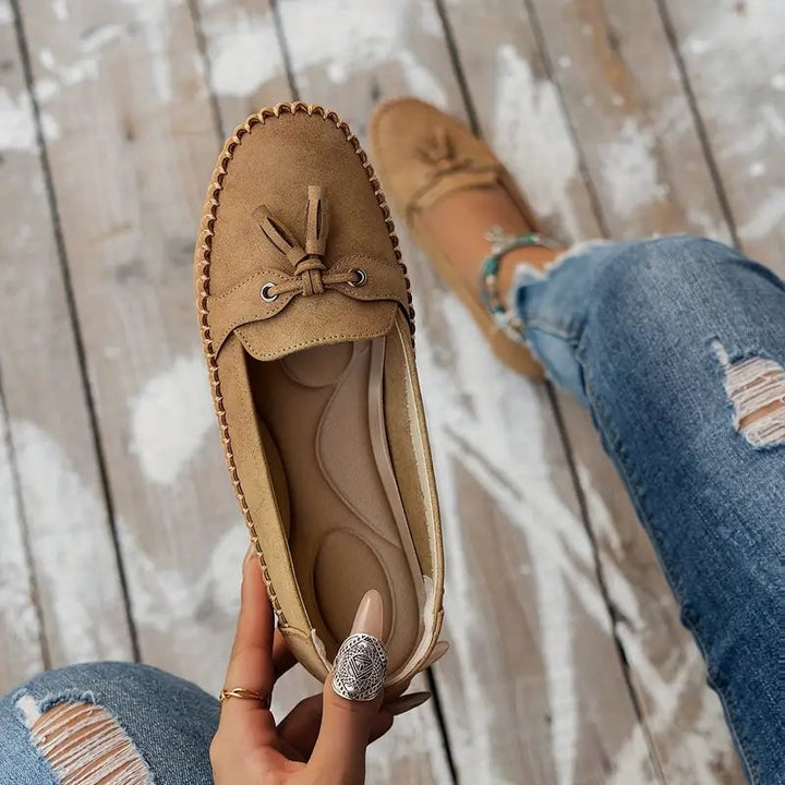 Women's pink loafers on a model walking, showcasing comfort fit