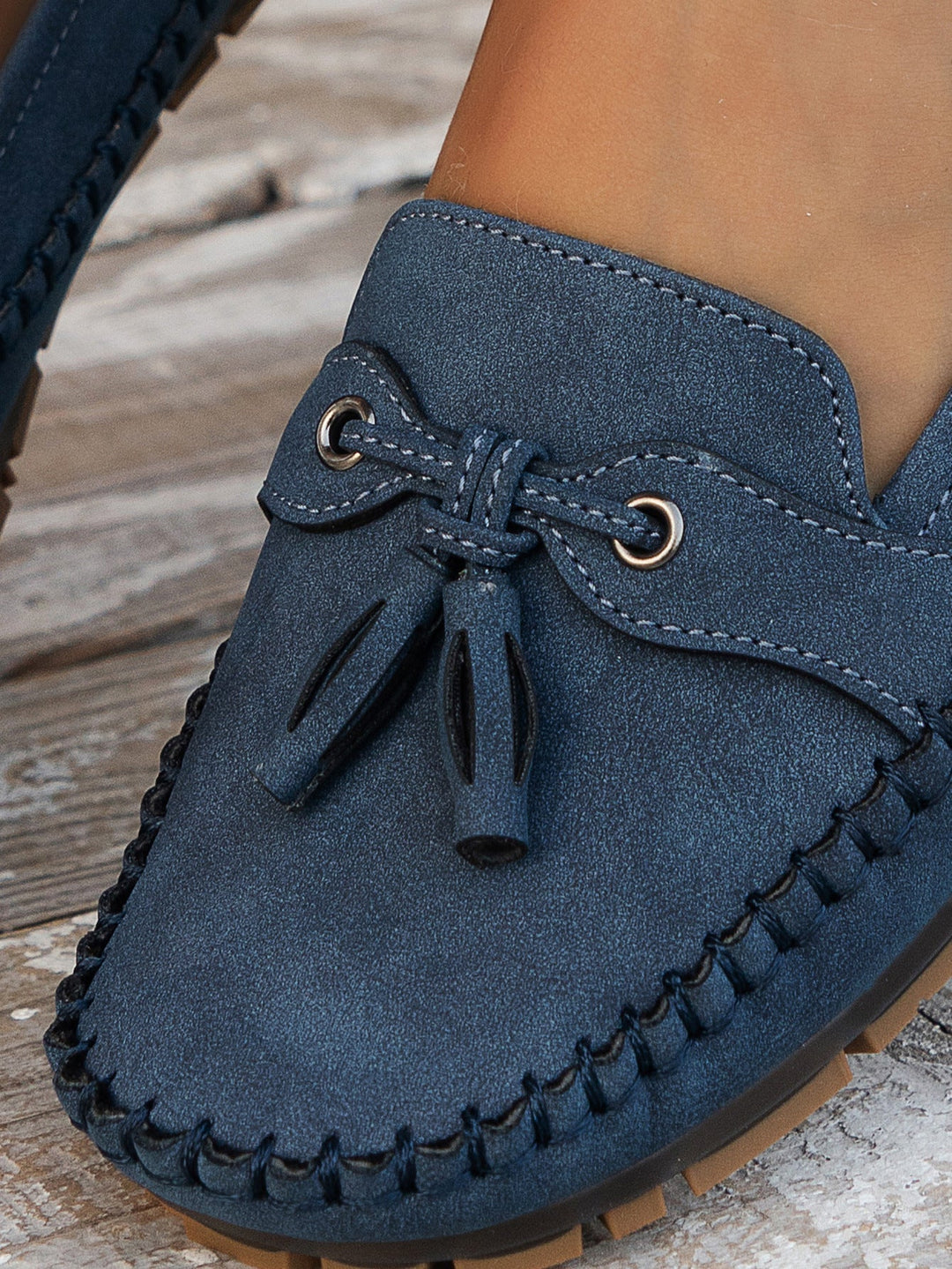Brown orthopedic loafers for women displayed on a wooden surface