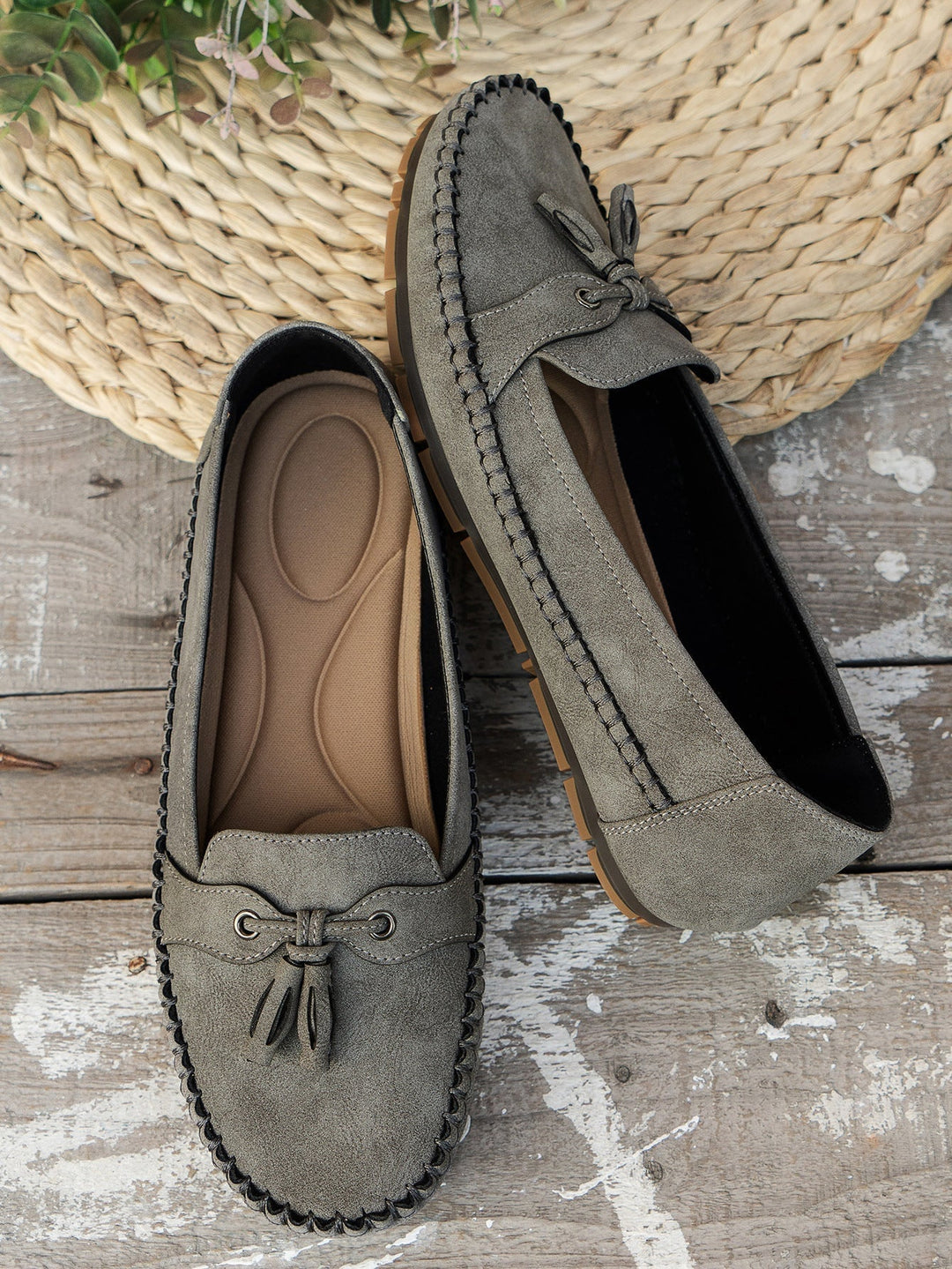 Overhead flat lay of all four color options: blue, gray, pink, and brown loafers