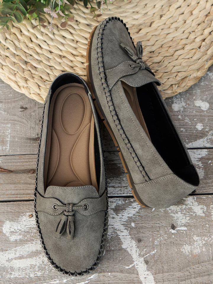 Overhead flat lay of all four color options: blue, gray, pink, and brown loafers