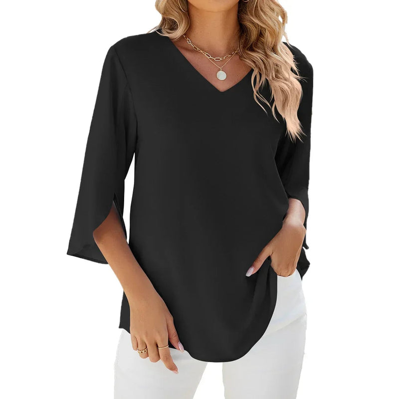 Close-up of the V-neckline detail on a relaxed-fit blouse in soft pink