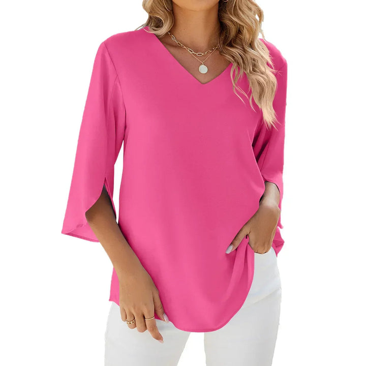 Woman in a black V-neck blouse paired with jeans, showcasing versatile everyday styling