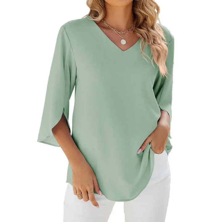 Side view of a lightweight green V-neck blouse with a relaxed silhouette