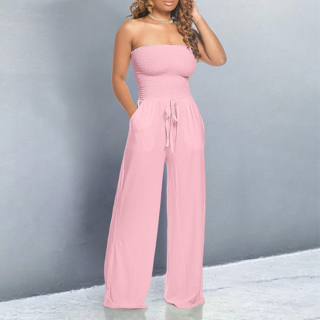 Model wearing a pink off-shoulder wide-leg jumpsuit with elastic neckline and drawstring waist, front view