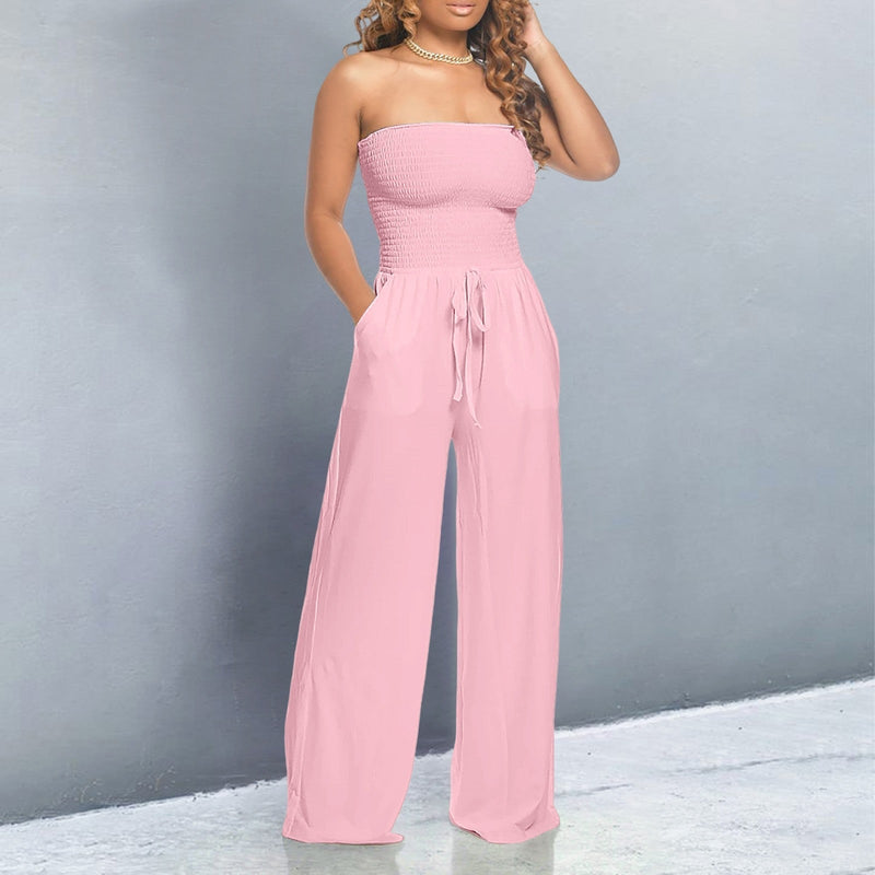 Model wearing a pink off-shoulder wide-leg jumpsuit with elastic neckline and drawstring waist, front view
